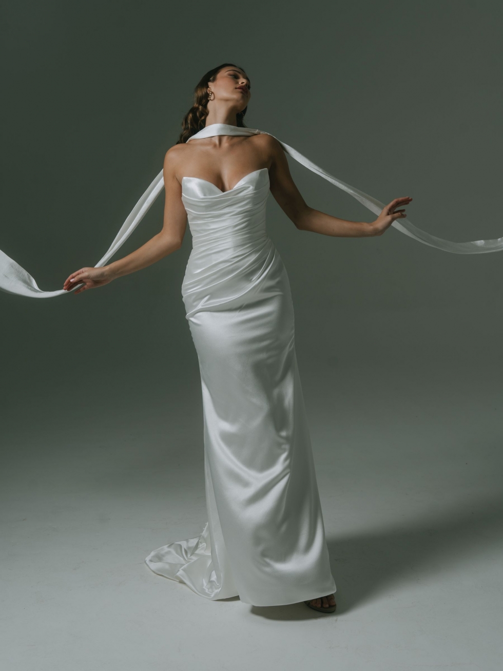 Camille: This elegant satin gown has a strapless bodice, asymmetrical pleats, a mid split, and an optional matching scarf