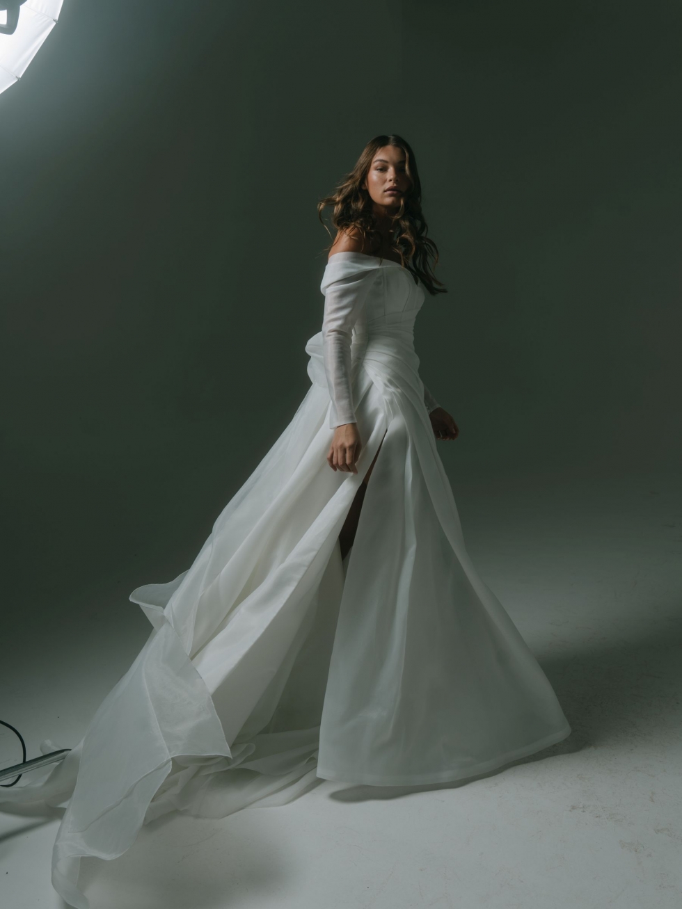 Luka: This ethereal gown features a sweetheart neckline, organza sleeves, a satin bodice, and a ruched organza overlay