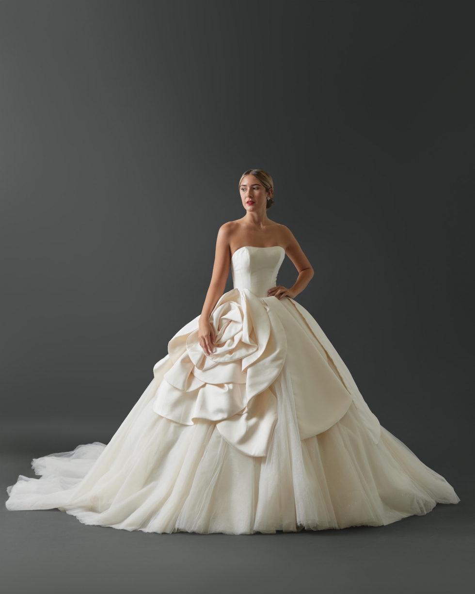 9002 Strapless silk Mikado gown. Clean tailored bodice with soft sweetheart neckline. Large, oversized Mikado petals and rosette framing skirt from the waist on top of full gathered tulle ball skirt.